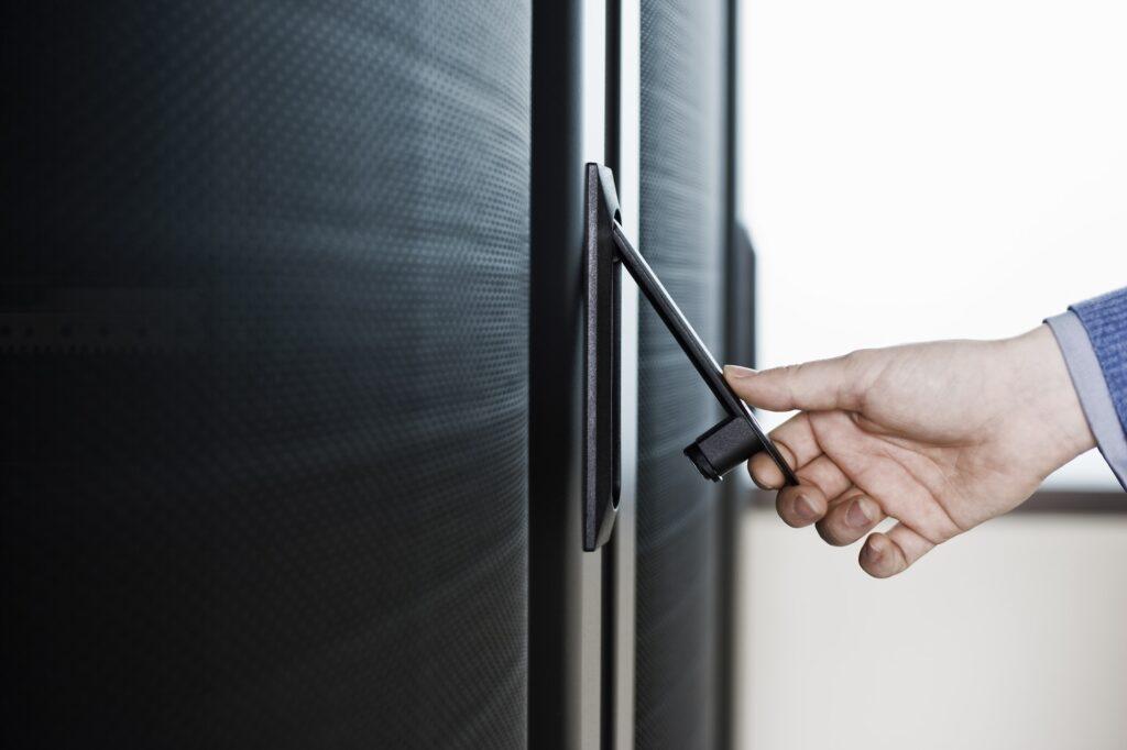 Opening the door to a rack holding servers in a computer server farm.